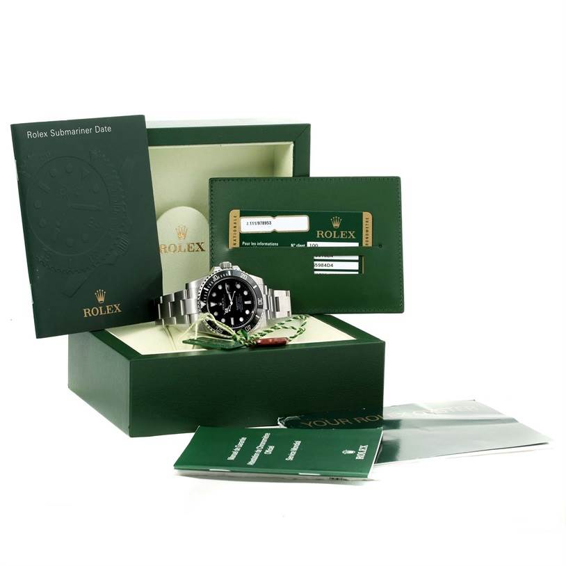 The image shows a Rolex Submariner 116610 Men
s Stainless Steel Black Dial 116610 Men
s Stainless Steel Black Dial watch displayed in its box, accompanied by warranty cards, booklets, and tags.