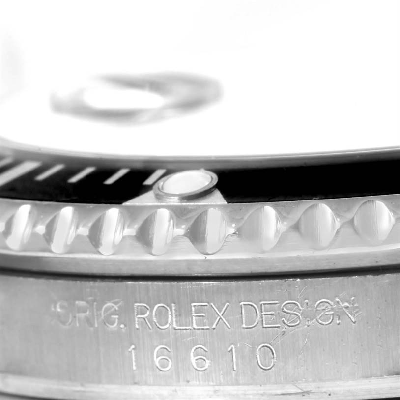 This image shows a close-up of the bezel and part of the dial of a Rolex Submariner 16610 Men
s Stainless Steel Black Dial 16610 Men
s Stainless Steel Black Dial, displaying its design engraving and model number 16610.
