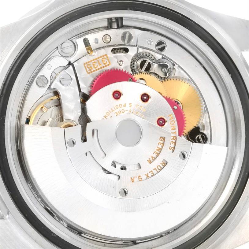 The image shows the internal mechanism and movement of a Rolex Submariner 16610 Men
s Stainless Steel Black Dial 16610 Men
s Stainless Steel Black Dial watch from the back.