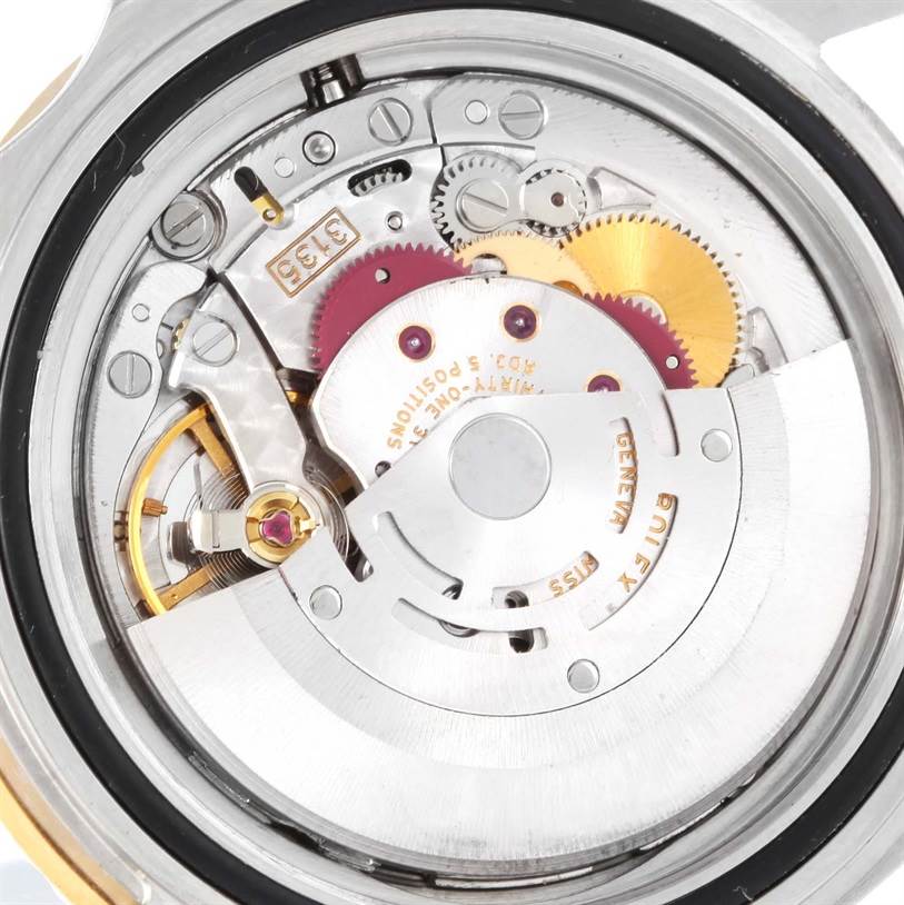 This image shows the movement and inner mechanical parts of the Rolex Submariner 16613 Men's Steel and Gold (two tone) Black Dial 16613 Men's Steel and Gold (two tone) Black Dial watch from a back view angle.