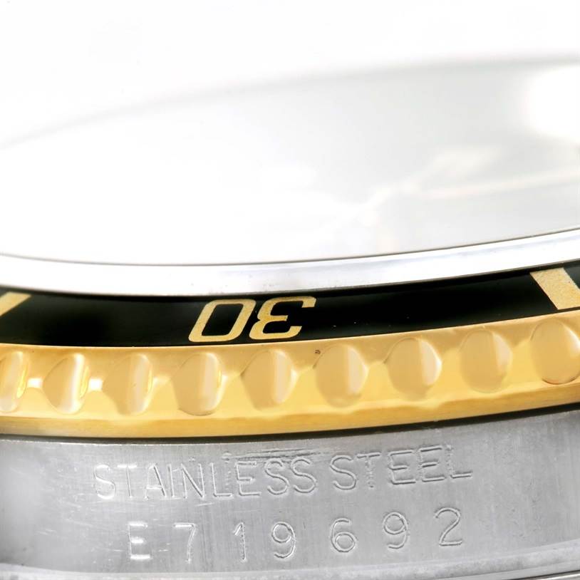 This image shows a close-up view of the bezel and stainless steel case of a Rolex Submariner 16613 Men's Steel and Gold (two tone) Black Dial 16613 Men's Steel and Gold (two tone) Black Dial watch, focusing on the number 30.