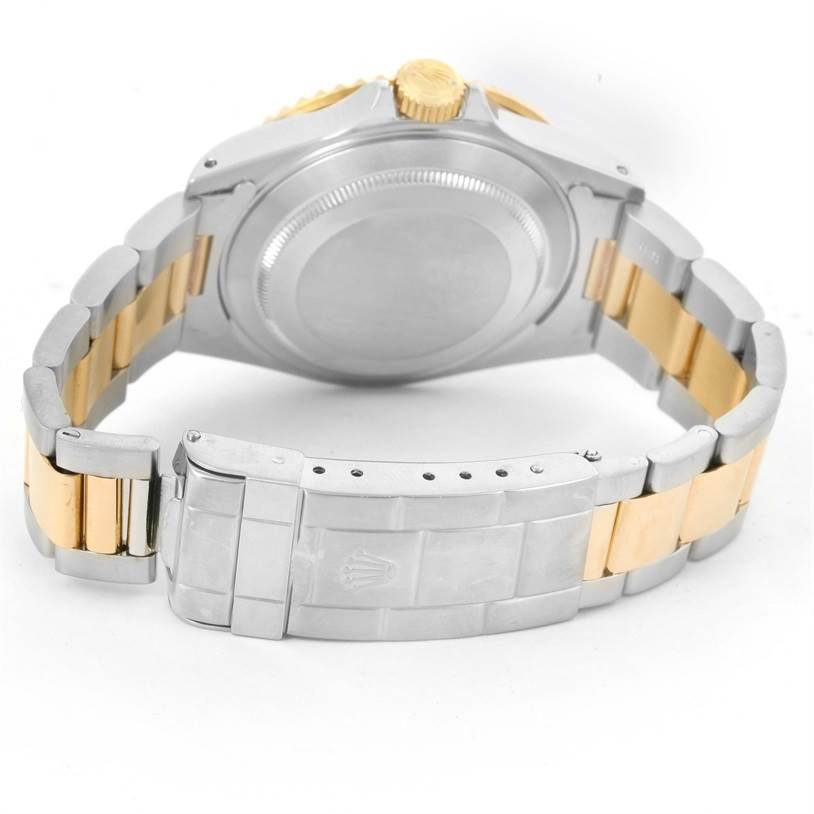 This image shows the back of a Rolex Submariner 16613 Men's Steel and Gold (two tone) Black Dial 16613 Men's Steel and Gold (two tone) Black Dial watch, highlighting the two-tone bracelet and deployment clasp.