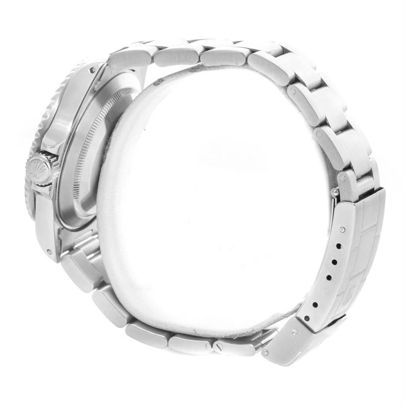 The image shows the side view of a Rolex Submariner 16610 Men
s Stainless Steel Black Dial 16610 Men
s Stainless Steel Black Dial watch, highlighting its crown and bracelet.