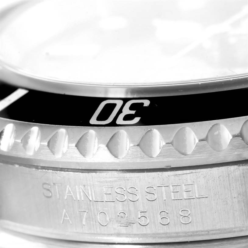 The image shows a close-up of the bezel and part of the case for a Rolex Submariner 16610 Men
s Stainless Steel Black Dial 16610 Men
s Stainless Steel Black Dial watch, highlighting the "30" marker and stainless steel engraving.