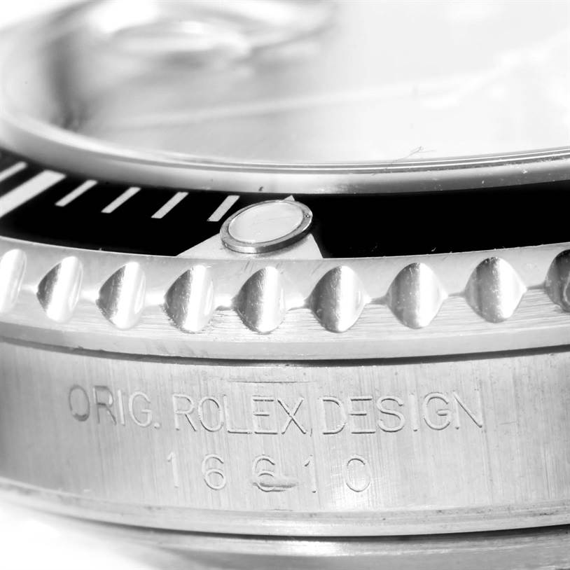 Close-up of the Rolex Submariner 16610 Men
s Stainless Steel Black Dial 16610 Men
s Stainless Steel Black Dial watch showing the bezel with minute markers and the engraved model number.