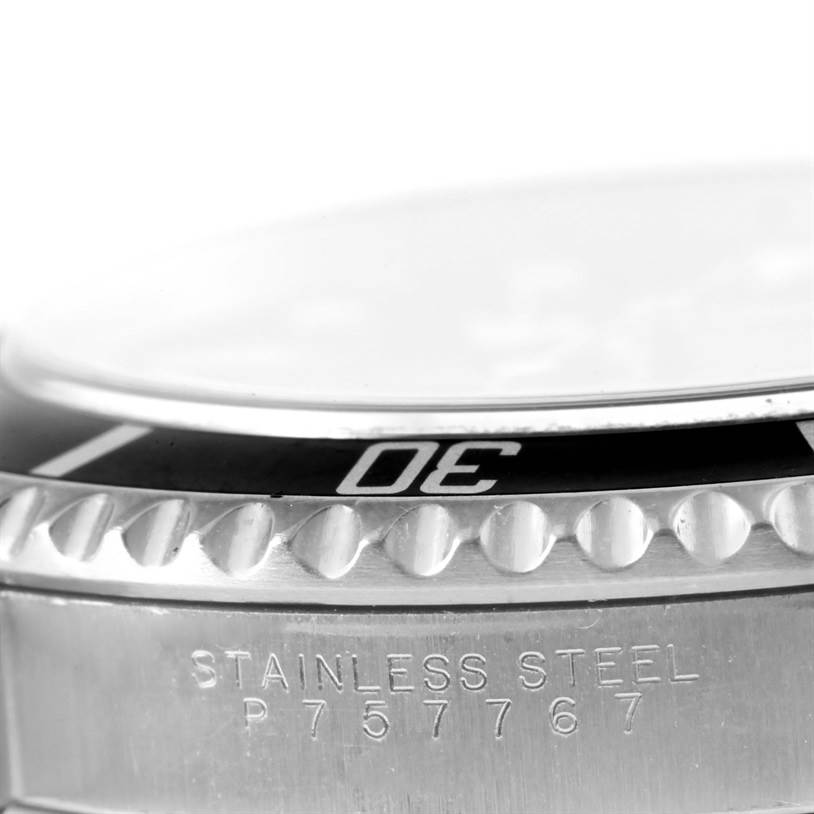 The image shows a close-up angle of the stainless steel bezel and part of the engraved case of a Rolex Submariner 14060 Men
s Stainless Steel Black Dial 14060 Men
s Stainless Steel Black Dial watch.