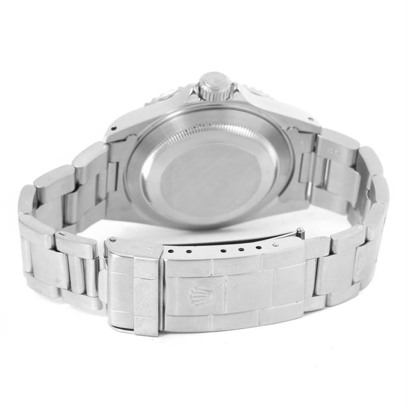 The image shows the back view of a Rolex Submariner 14060 Men
s Stainless Steel Black Dial 14060 Men
s Stainless Steel Black Dial watch, focusing on the case back and bracelet clasp.