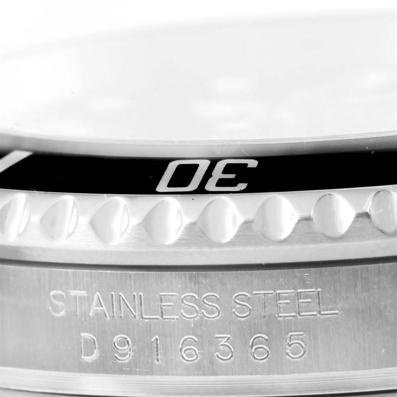 This image shows a close-up of the bezel and case with the serial number of a Rolex Submariner 16610 Men
s Stainless Steel Black Dial 16610 Men
s Stainless Steel Black Dial watch.