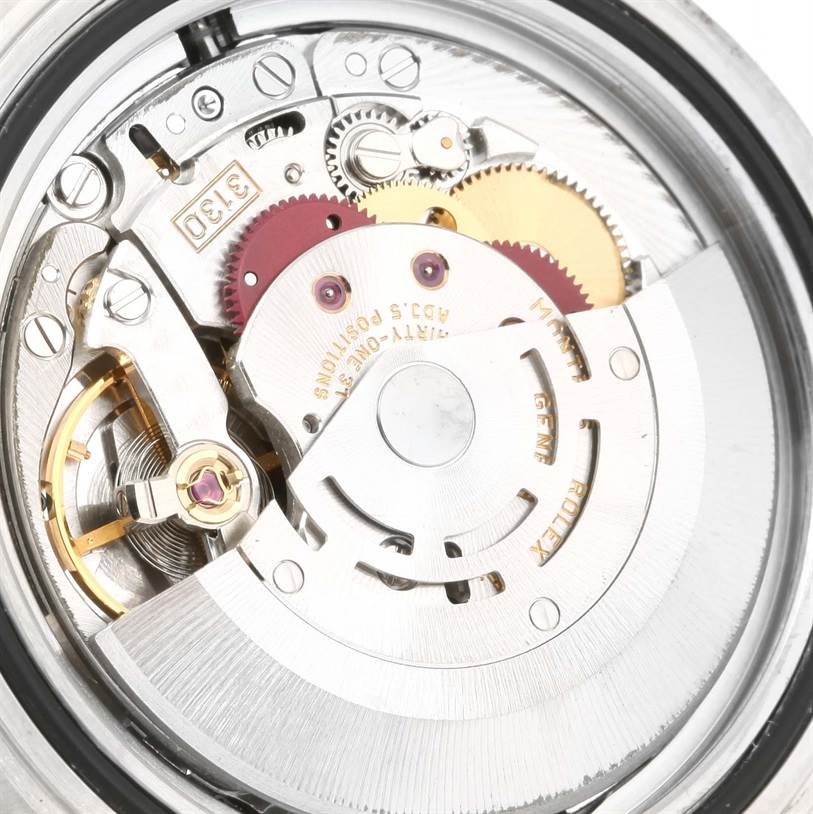 Close-up of the Rolex Submariner 14060 Men
s Stainless Steel Black Dial 14060 Men
s Stainless Steel Black Dial
s internal mechanical movement parts, showing gears and the winding rotor.