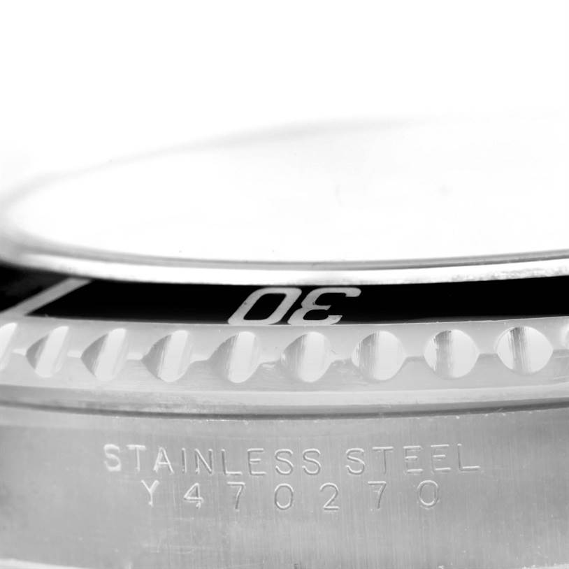 This close-up angle of the Rolex Submariner 14060 Men
s Stainless Steel Black Dial 14060 Men
s Stainless Steel Black Dial watch shows the bezel and part of the stainless steel casing with engravings.