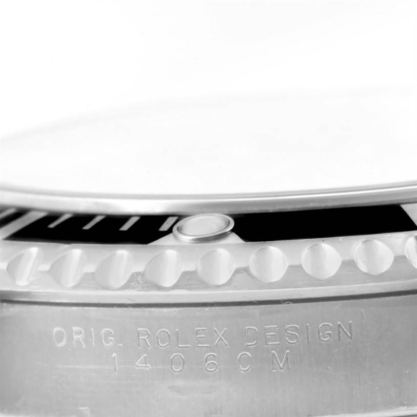 This close-up image of the Rolex Submariner 14060 Men
s Stainless Steel Black Dial 14060 Men
s Stainless Steel Black Dial shows the watch
s bezel and part of the case with model engraving.