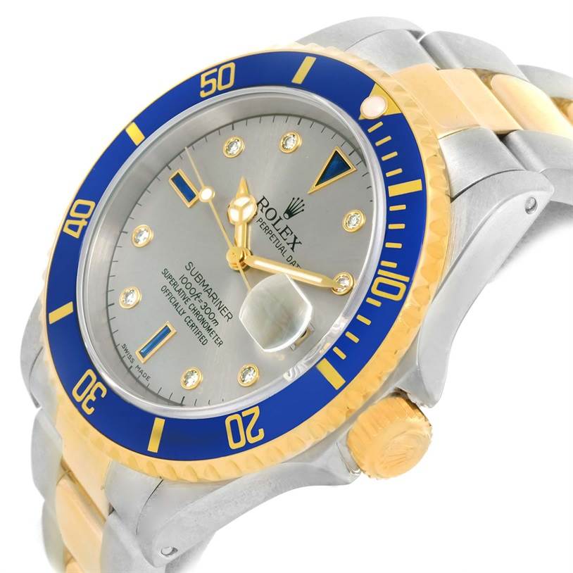 The Rolex Submariner 16613 Men's Steel and Gold (two tone) Grey Dial 16613 Men's Steel and Gold (two tone) Grey Dial watch is shown at a slight angle, highlighting the bezel, crown, face, and part of the bracelet.