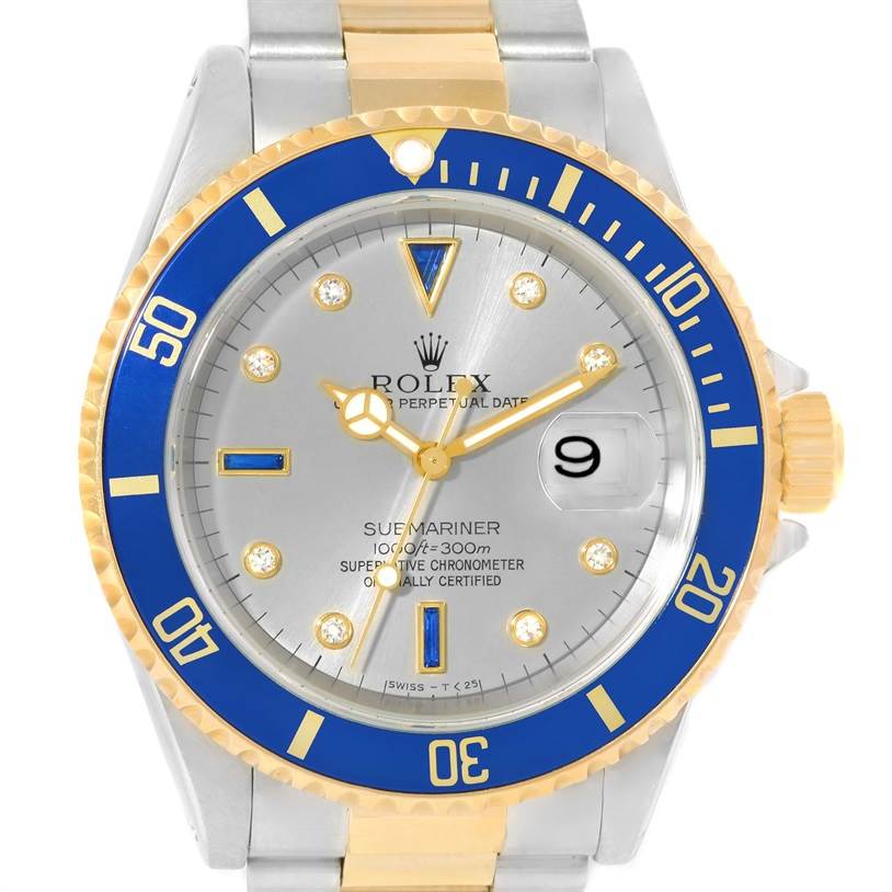 The image shows the front view of a Rolex Submariner 16613 Men's Steel and Gold (two tone) Grey Dial 16613 Men's Steel and Gold (two tone) Grey Dial watch with a silver dial, blue and gold bezel, and two-tone bracelet.