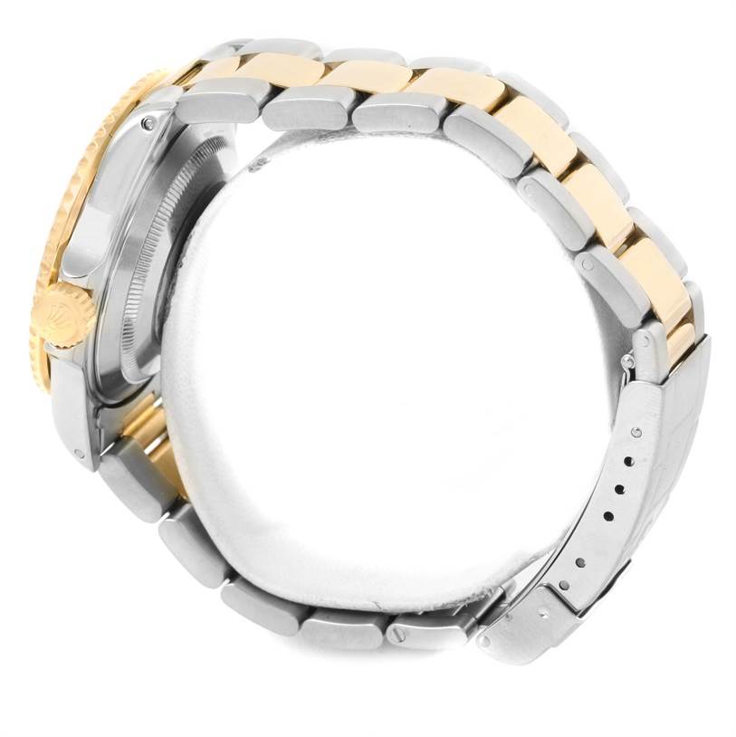 The image shows a side view of the Rolex Submariner 16613 Men's Steel and Gold (two tone) Grey Dial 16613 Men's Steel and Gold (two tone) Grey Dial watch, highlighting the crown and the two-tone bracelet.