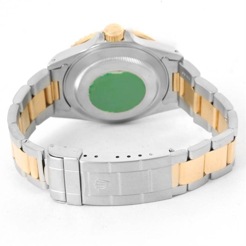 This image shows the back case, crown, and bracelet clasp of a Rolex Submariner 16613 Men's Steel and Gold (two tone) Grey Dial 16613 Men's Steel and Gold (two tone) Grey Dial watch viewed from the rear angle.