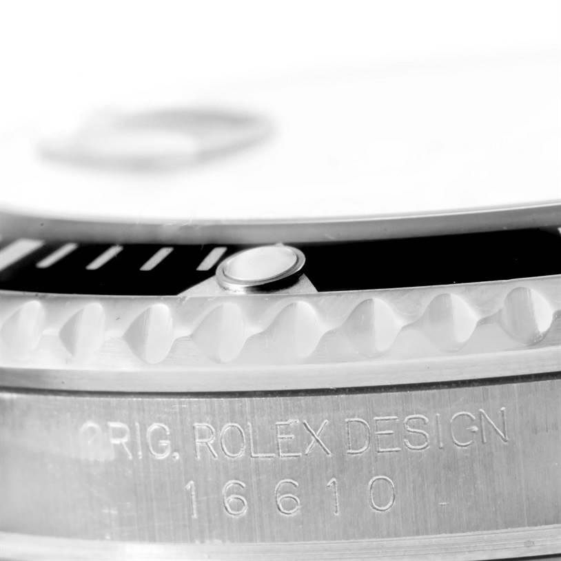 This close-up image shows part of the bezel and engravings of a Rolex Submariner 16610 Men
s Stainless Steel Black Dial 16610 Men
s Stainless Steel Black Dial model.