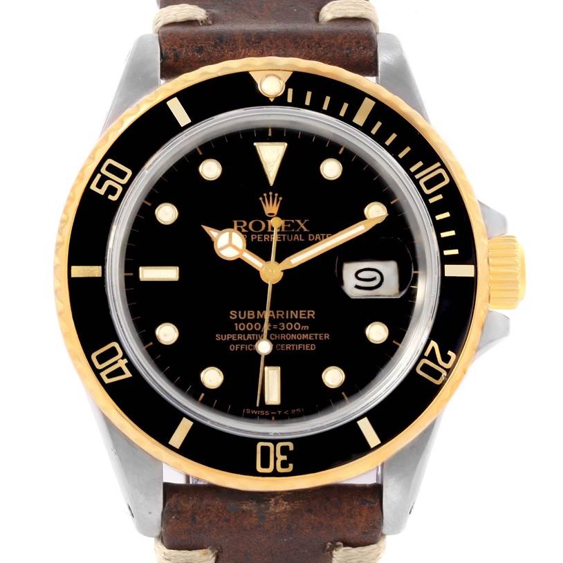 This image shows the front view of a Rolex Submariner 16803 Men
s Steel and Gold (two tone) Black Dial 16803 Men
s Steel and Gold (two tone) Black Dial watch, highlighting the dial, bezel, and date window.