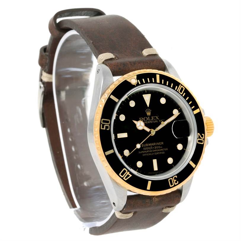 The image shows a Rolex Submariner 16803 Men
s Steel and Gold (two tone) Black Dial 16803 Men
s Steel and Gold (two tone) Black Dial watch at a three-quarter angle, highlighting the dial, bezel, and strap.