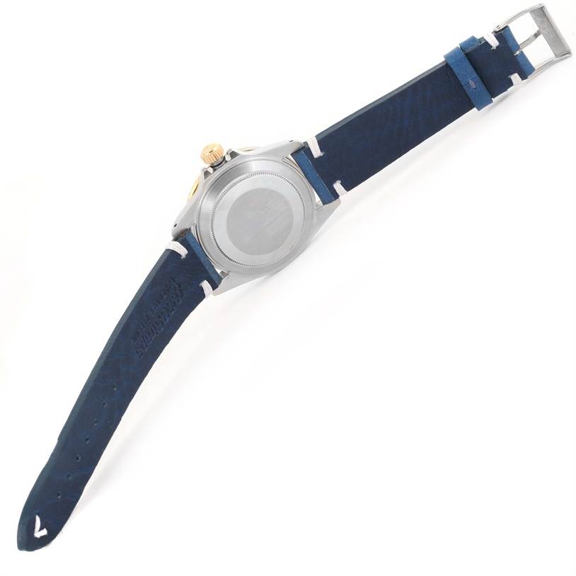 The image shows the back and side view of a Rolex Submariner 16803 Men
s Steel and Gold (two tone) Blue Dial 16803 Men
s Steel and Gold (two tone) Blue Dial watch with a blue leather strap.