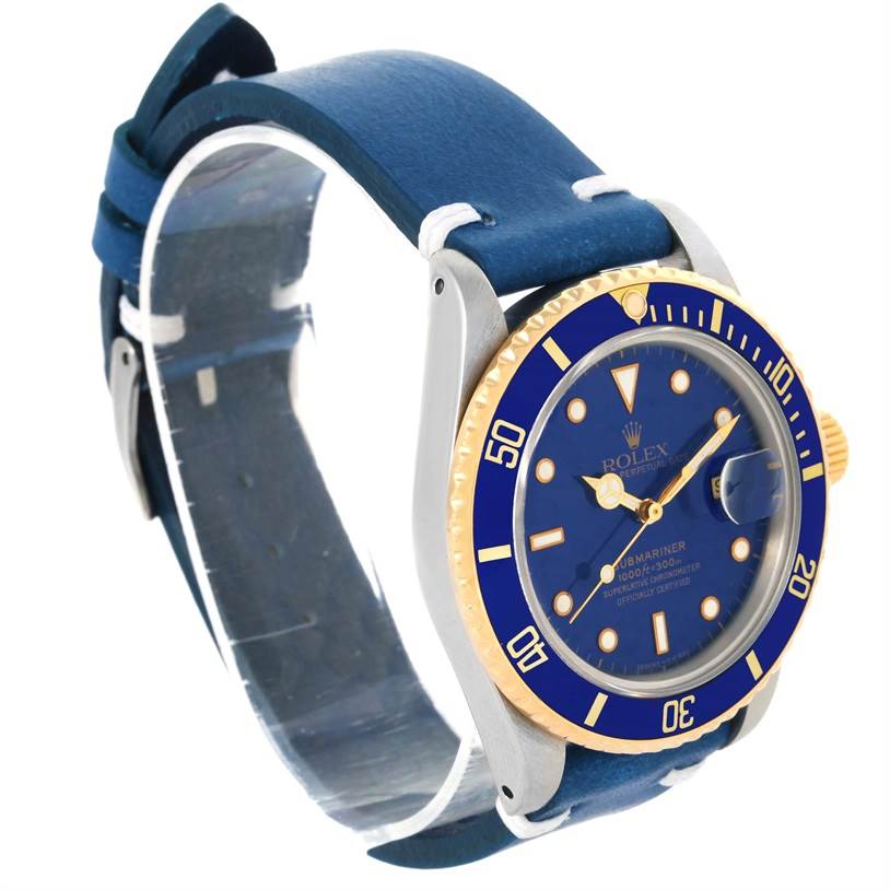 The image shows a Rolex Submariner 16803 Men
s Steel and Gold (two tone) Blue Dial 16803 Men
s Steel and Gold (two tone) Blue Dial watch at a slight angle, highlighting its blue bezel, blue dial, and blue leather strap.