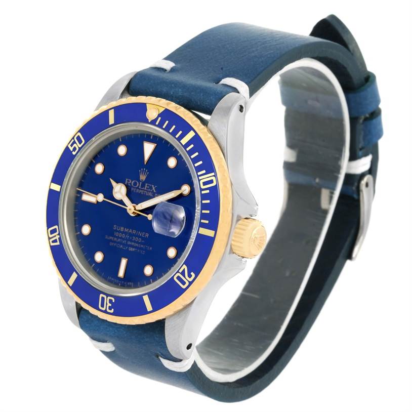 The image shows a Rolex Submariner 16803 Men
s Steel and Gold (two tone) Blue Dial 16803 Men
s Steel and Gold (two tone) Blue Dial watch from an angled side view, highlighting its blue dial, bezel, and leather strap.