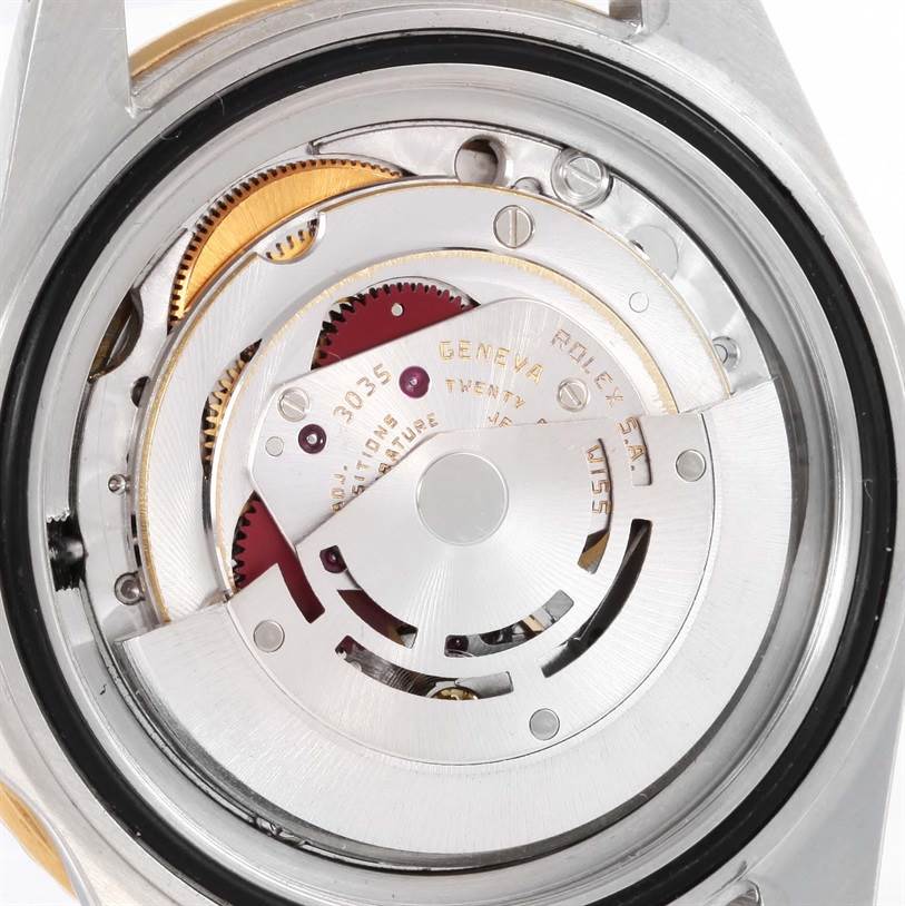 The image shows the internal mechanism of a Rolex Submariner 16803 Men
s Steel and Gold (two tone) Blue Dial 16803 Men
s Steel and Gold (two tone) Blue Dial watch, viewed from the back with the case removed.