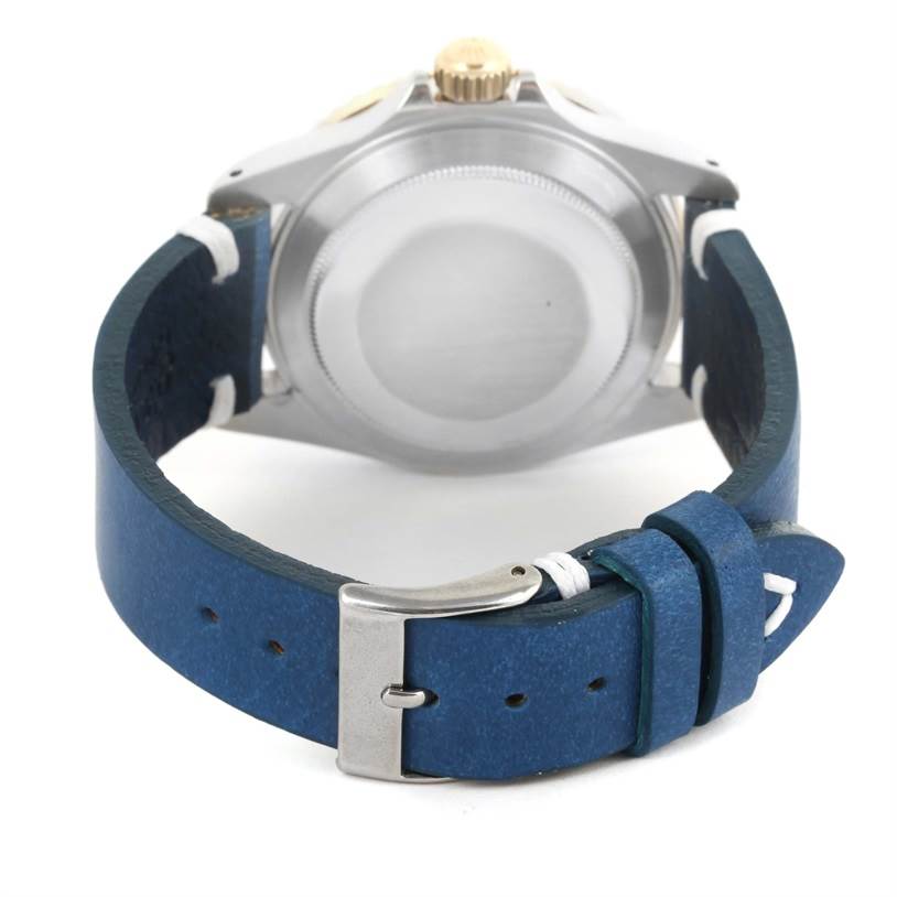 This image shows the back view of a Rolex Submariner 16803 Men
s Steel and Gold (two tone) Blue Dial 16803 Men
s Steel and Gold (two tone) Blue Dial watch, highlighting its case back, crown, and blue leather strap with a buckle.