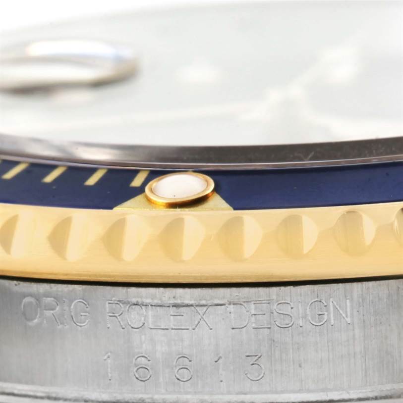 This image shows a close-up angle of the bezel and outer casing of a Rolex Submariner 16613 Men
s Steel and Gold (two tone) Blue Dial 16613 Men
s Steel and Gold (two tone) Blue Dial watch.