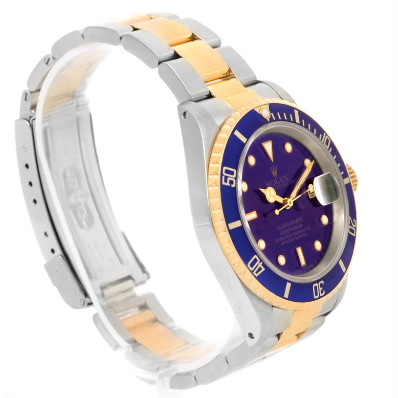 The image shows a side angle of a Rolex Submariner 16613 Men
s Steel and Gold (two tone) Blue Dial 16613 Men
s Steel and Gold (two tone) Blue Dial watch, focusing on its bezel, dial, and two-tone bracelet.
