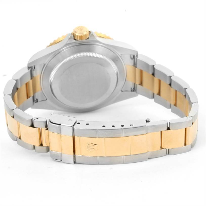 The image shows the back view of a Rolex Submariner 16613 Men's Steel and Gold (two tone) Blue Dial 16613 Men's Steel and Gold (two tone) Blue Dial, highlighting the clasp, bracelet, and caseback.