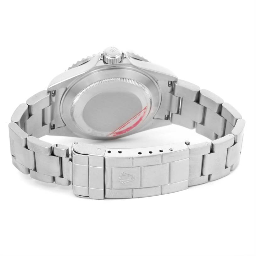 The image shows the Rolex Submariner 16610 Men
s Stainless Steel Black Dial 16610 Men
s Stainless Steel Black Dial watch from the back, highlighting the case back and metal bracelet.