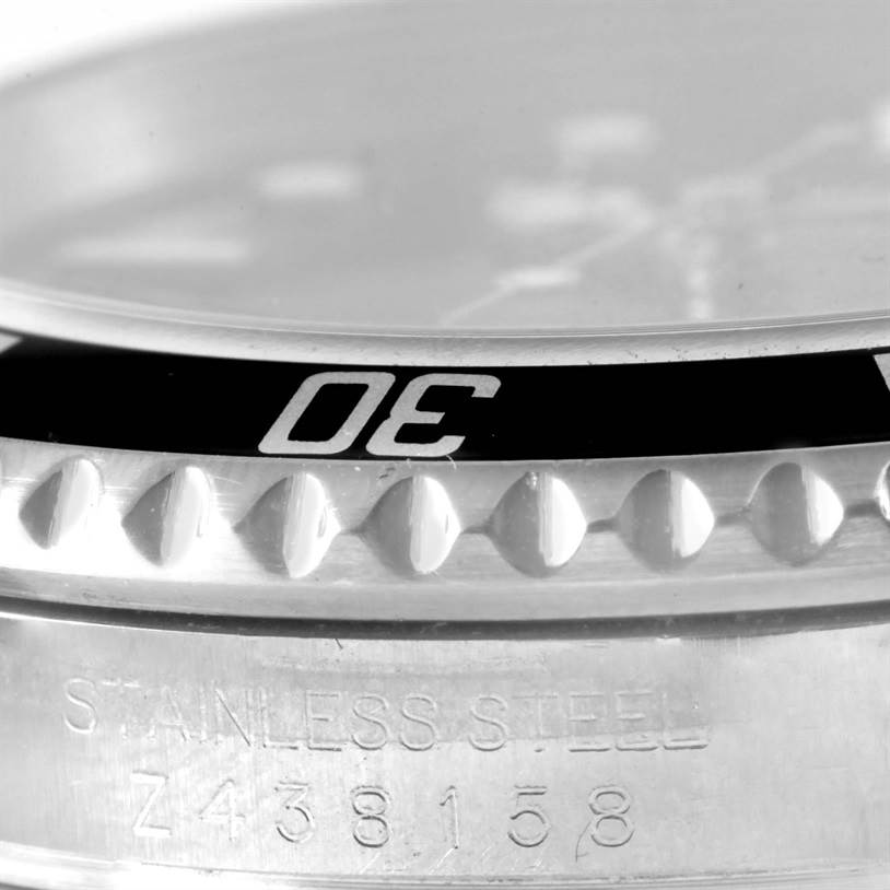 The close-up image focuses on the bezel and case of the Rolex Submariner 16610 Men
s Stainless Steel Black Dial 16610 Men
s Stainless Steel Black Dial watch, showing the "30" indicator and part of its serial number.