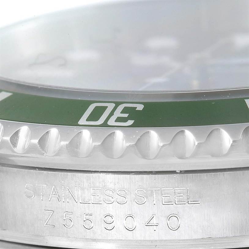 The image shows a close-up of the bezel and case with markings on a Rolex Submariner 16610LV Men
s Stainless Steel Black Dial 16610LV Men
s Stainless Steel Black Dial watch.