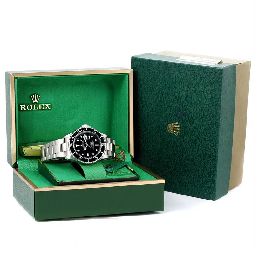 The image shows a Rolex Submariner 168000 Men
s Stainless Steel Black Dial 168000 Men
s Stainless Steel Black Dial watch displayed in its open green box, with its bracelet laid out and packaging visible.