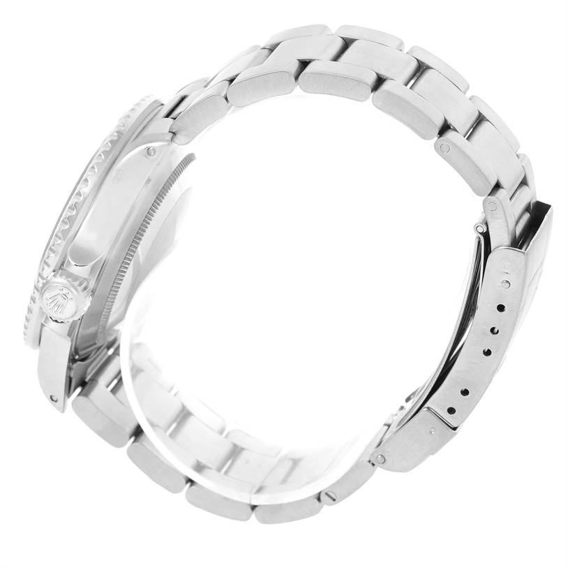 The image shows a side view of a Rolex Submariner 168000 Men
s Stainless Steel Black Dial 168000 Men
s Stainless Steel Black Dial watch highlighting the bracelet and the crown.