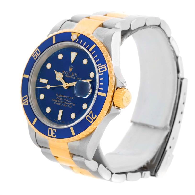 This Rolex Submariner 16613 Men
s Steel and Gold (two tone) Blue Dial 16613 Men
s Steel and Gold (two tone) Blue Dial watch is shown at a three-quarter angle, highlighting the blue bezel, blue dial, and two-tone metal bracelet.