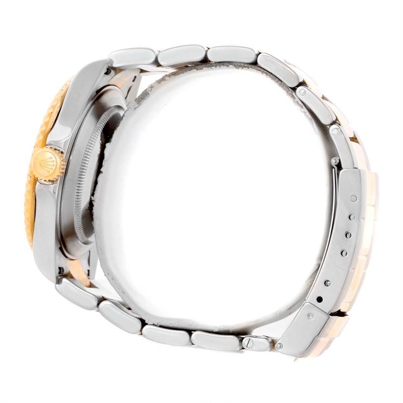 The image shows a side view of a Rolex Submariner 16613 Men
s Steel and Gold (two tone) Blue Dial 16613 Men
s Steel and Gold (two tone) Blue Dial watch displaying the crown and part of the bracelet.