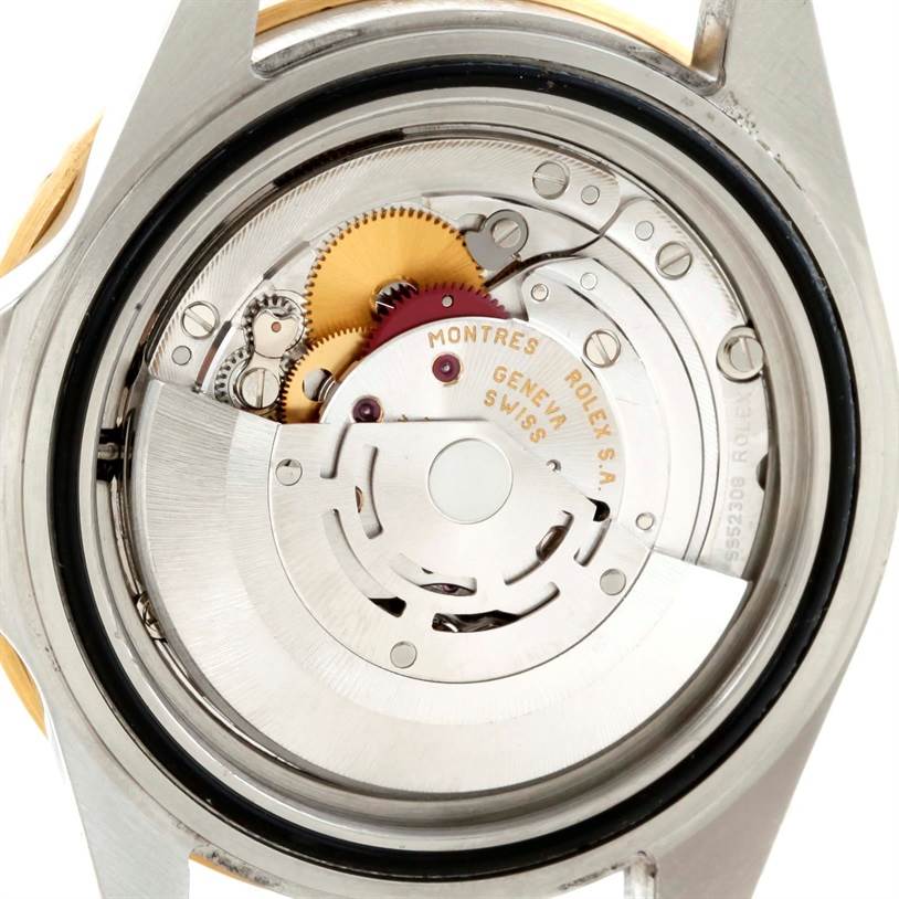 The image shows the open case back of a Rolex Submariner 16613 Men
s Steel and Gold (two tone) Blue Dial 16613 Men
s Steel and Gold (two tone) Blue Dial, revealing its intricate mechanical movement.