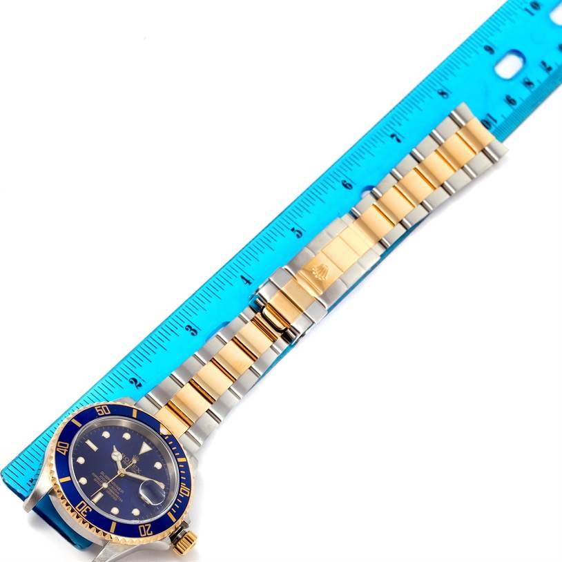 The Rolex Submariner 16613 Men's Steel and Gold (two tone) Blue Dial 16613 Men's Steel and Gold (two tone) Blue Dial watch is shown from a top-down angle, featuring the face, bezel, and bracelet in the image.