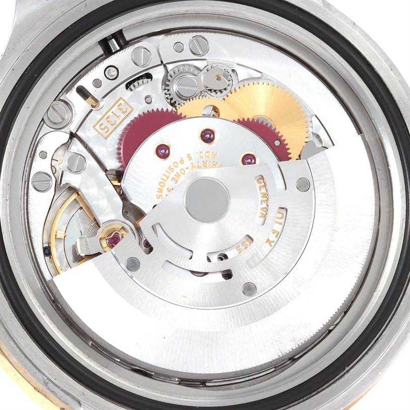 The image shows a close-up of the internal mechanical movement of a Rolex Submariner 16613 Men's Steel and Gold (two tone) Black Dial 16613 Men's Steel and Gold (two tone) Black Dial watch.
