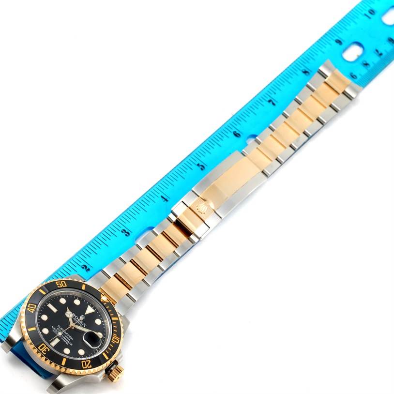 The Rolex Submariner 116613LN Men's Steel and Gold (two tone) Black Dial 116613LN Men's Steel and Gold (two tone) Black Dial watch is shown from an overhead angle with the face, bezel, bracelet, and clasp visible.