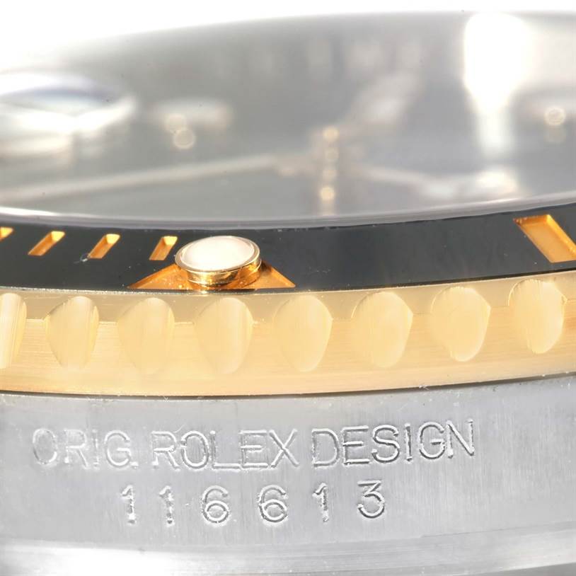 This image shows a close-up of the bezel and case of a Rolex Submariner 116613LN Men's Steel and Gold (two tone) Black Dial 116613LN Men's Steel and Gold (two tone) Black Dial, highlighting the model number 116613.