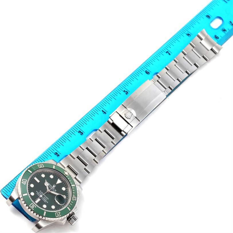 The image shows a top-down view of a Rolex Submariner 116610LV Men's Stainless Steel Green Dial 116610LV Men's Stainless Steel Green Dial watch, with its bracelet fully extended and measured against a blue ruler.