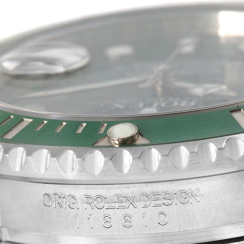 This close-up angle of the Rolex Submariner 116610LV Men's Stainless Steel Green Dial 116610LV Men's Stainless Steel Green Dial watch shows the green bezel, crystal, and engraved case.