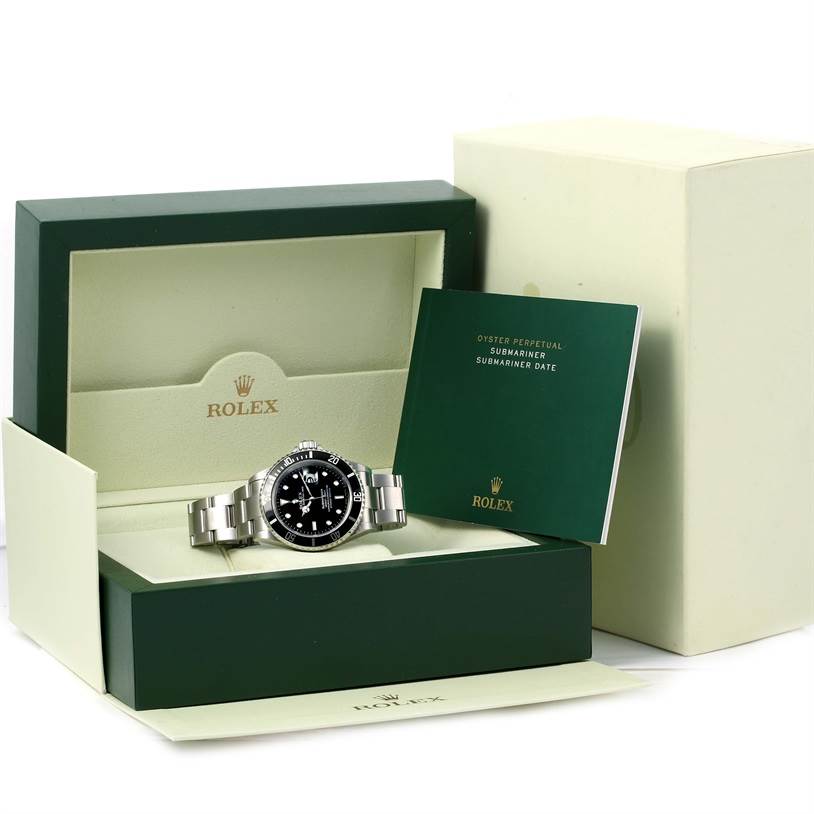 The image shows a Rolex Submariner 16610 Men
s Stainless Steel Black Dial 16610 Men
s Stainless Steel Black Dial watch with its opened box and accompanying booklet.