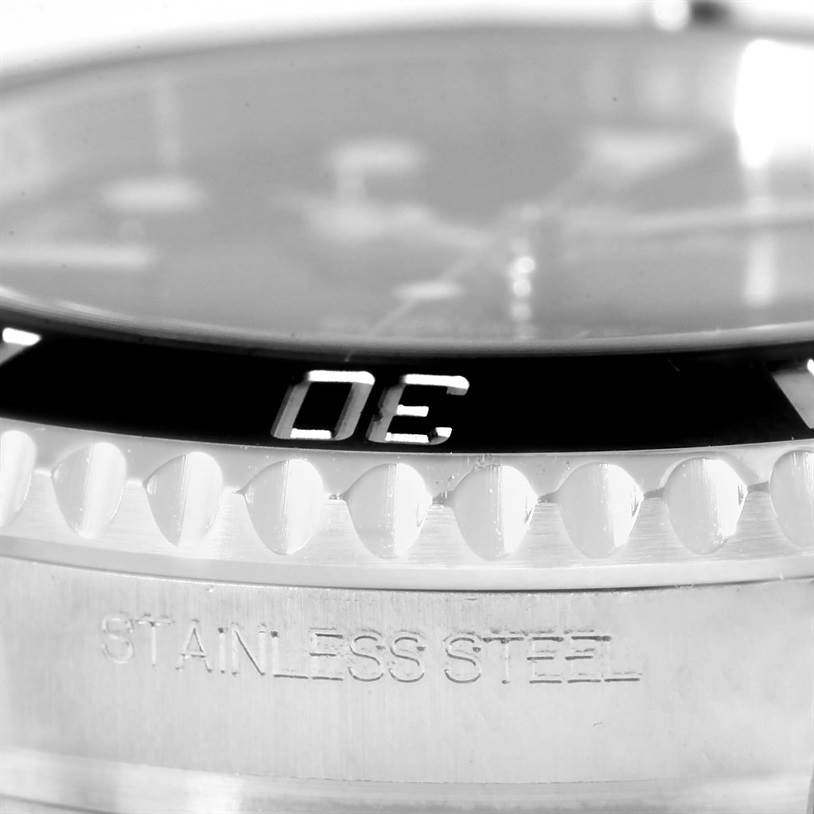 This image shows a close-up of the bezel and case of the Rolex Submariner 114060 Men
s Stainless Steel Black Dial 114060 Men
s Stainless Steel Black Dial watch, with "STAINLESS STEEL" engraved.