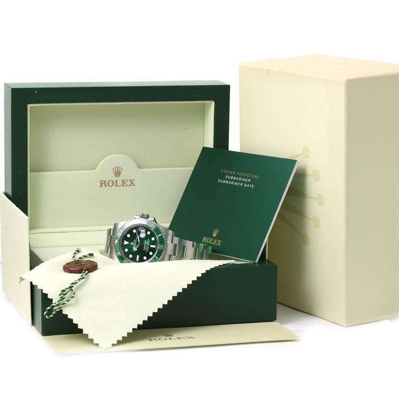 The image shows a Rolex Submariner 116610LV Men's Stainless Steel Green Dial 116610LV Men's Stainless Steel Green Dial watch, box, manual, and tags in a presentation angle with packaging.