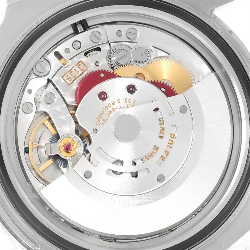The image shows the internal mechanism of a Rolex Submariner 116610LV Men's Stainless Steel Green Dial 116610LV Men's Stainless Steel Green Dial watch from a rear angle, displaying gears and movement components.