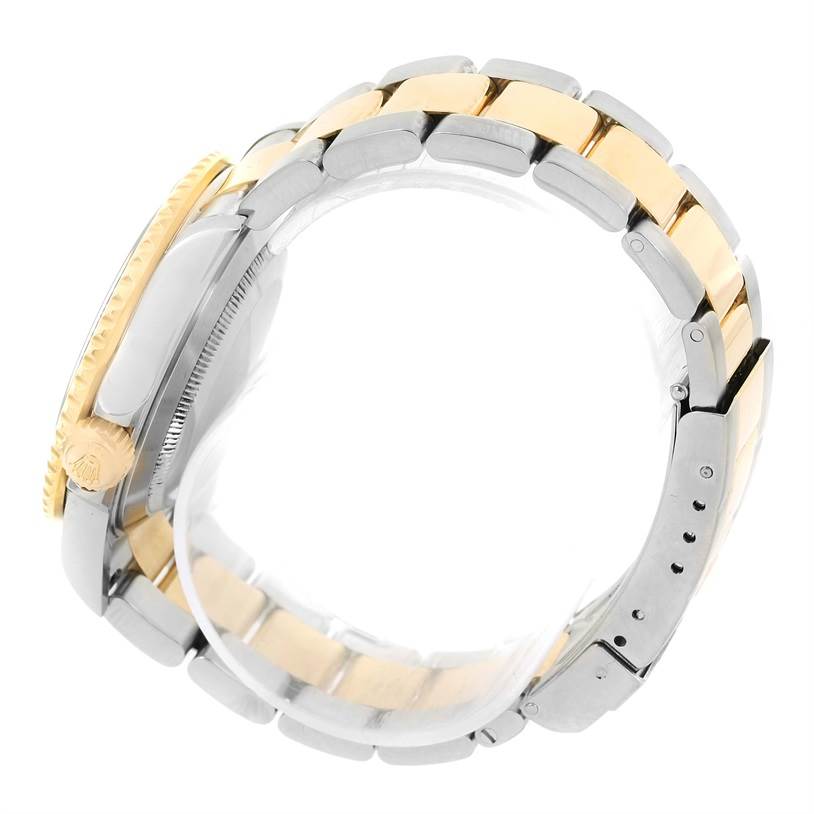 The image shows a side view of the Rolex Submariner 16613 Men's Steel and Gold (two tone) Blue Dial 16613 Men's Steel and Gold (two tone) Blue Dial's two-tone bracelet and crown.