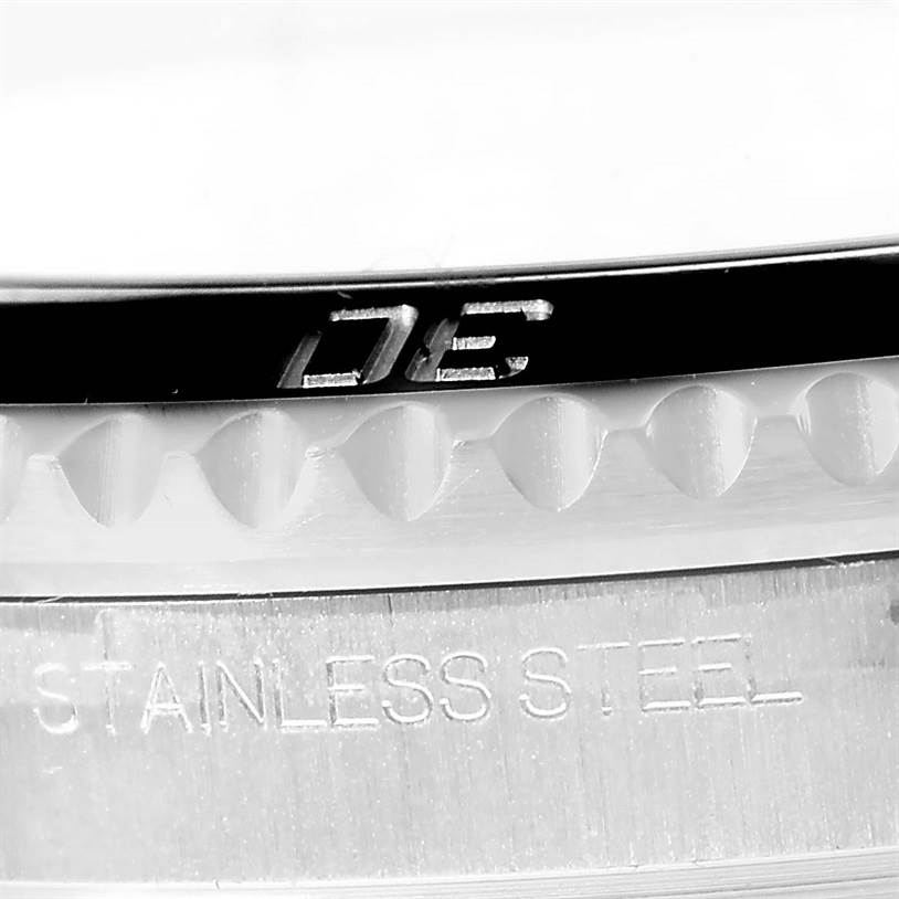 This close-up image of the Rolex Submariner 116610 Men
s Stainless Steel Black Dial 116610 Men
s Stainless Steel Black Dial watch shows part of the bezel and the "STAINLESS STEEL" engraving.